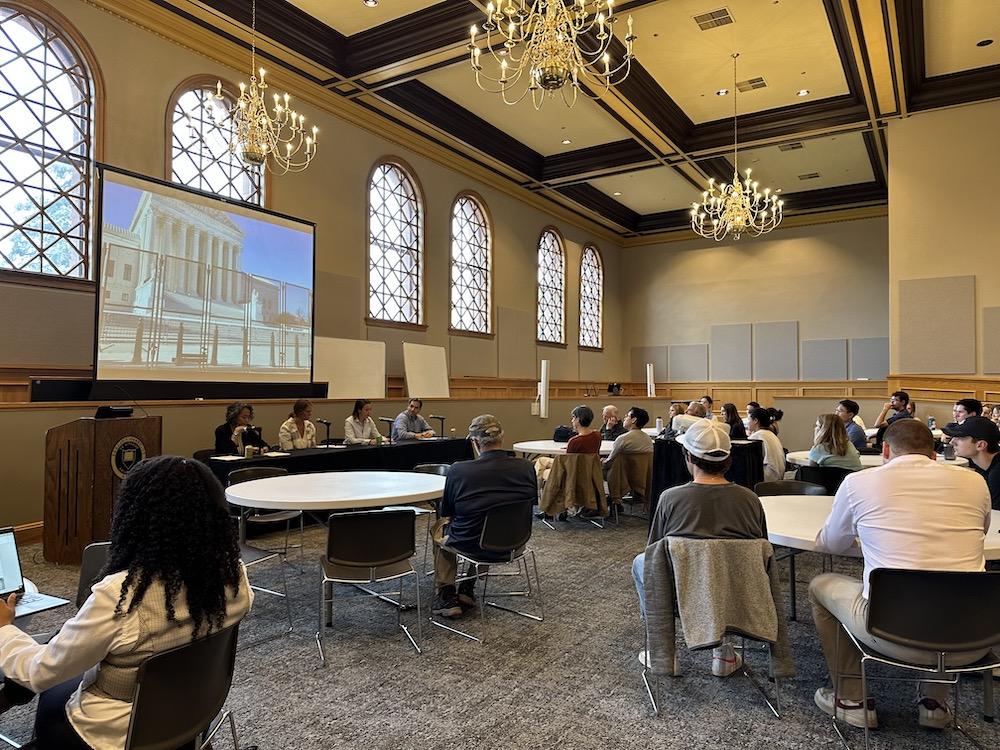 college students listening to a panel of political science experts